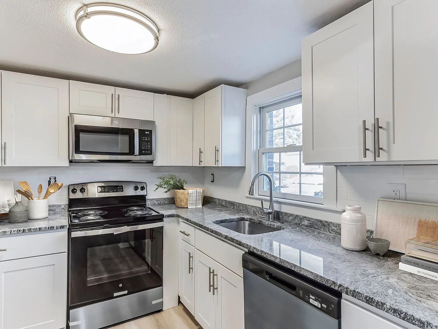 Revel Apartments — kitchen with double sink and window