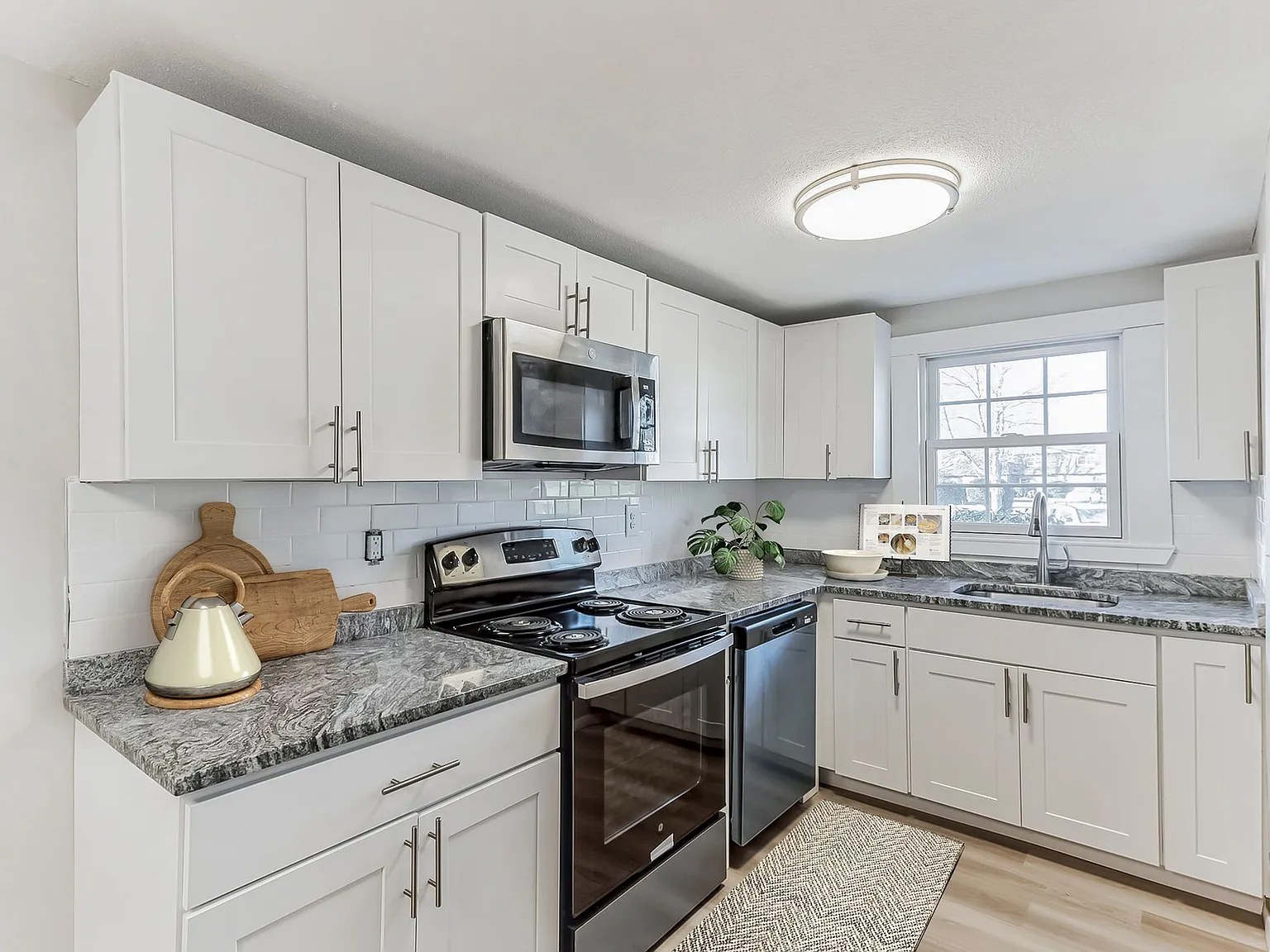 Revel Apartments — kitchen with granite counters and stainless appliances